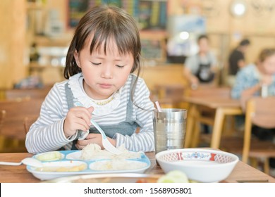 Little Asian Child Girl With Unhappy Face While Having Lunch On Table In Restaurant,picky Eater Don't Want To Eat Or Not Hungry