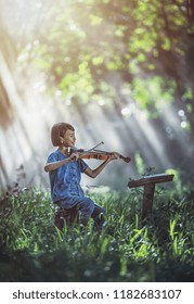 Little Asian Child Playing Violin At Outdoors