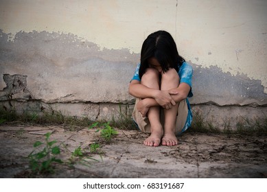 Little Asian Child Sitting And Waiting Someone. Depressed Asian Girl. Young Asian Girl Sad