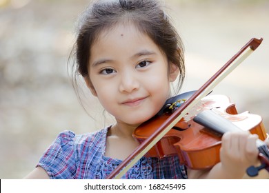 Little Asian Child With Violin Outdoor