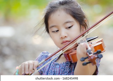 Little Asian Child With Violin Outdoor