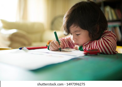 Little Asian Chinese Boy Child Kid Writing And Drawing On A Table. Preschooler. Early Learning. Kindergarten Homework. Homeschooler Art Class. Playschool At Home. Gifted Student. Day Activity. 