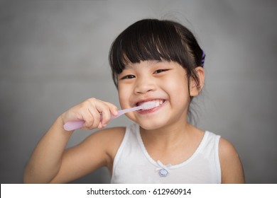 Little Asian Cute Girl Brush Teeth