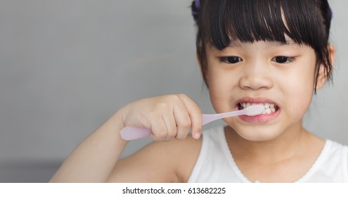 Little Asian Cute Girl Brush Teeth