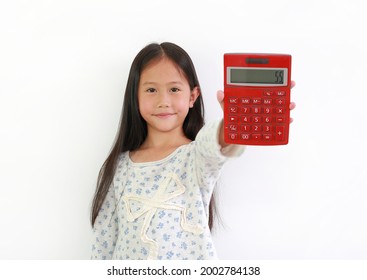Little Asian girl child showing Calculator on white background. Kid holding a red calculator