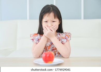 Little Asian Girl Close Her Mouth By Hands,refuse To Eat Apple For Snack.