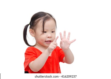 Little Asian Girl Counting Her Finger Over White