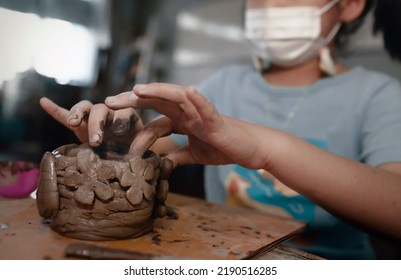 Little Asian Girl Creating Potter Clay Bowl At Home.Education,hobby And  Handicraft Concept.