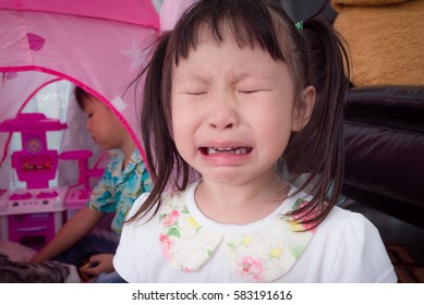 Little Asian Girl Crying Because A Boy Playing Her Toy