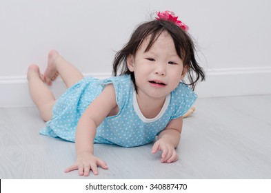 Little Asian Girl Crying On The Floor