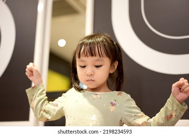 Little Asian Girl Eating Ice Cream At Restaurant. Soft Focus. Copy Space.