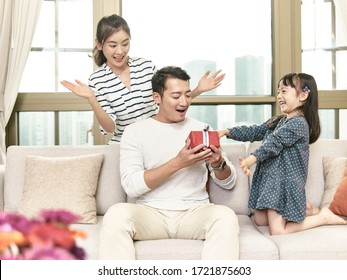 Little Asian Girl Giving Father A Birthday Gift