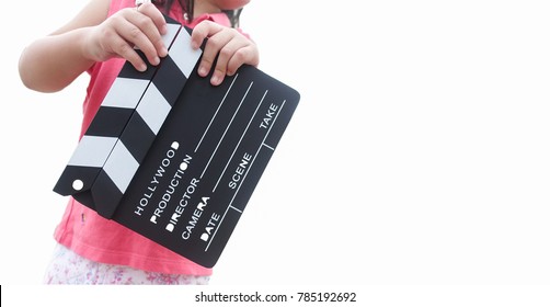Little asian girl hands holding clapper board for making video cinema in studio.Kids Movie production with clapper board or slate film concept.isolated on white background.