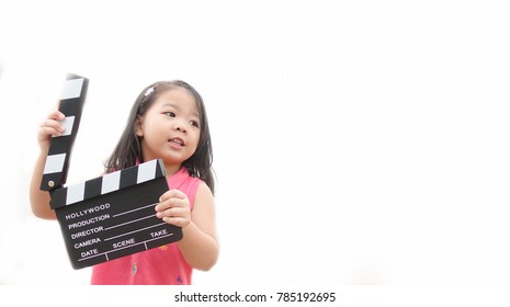 Little Asian Girl Hands Holding Clapper Board For Making Video Cinema In Studio.Kids Movie Production With Clapper Board Or Slate Film Concept.isolated On White Background.