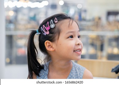 Little Asian Girl Having Ear Piercing Process