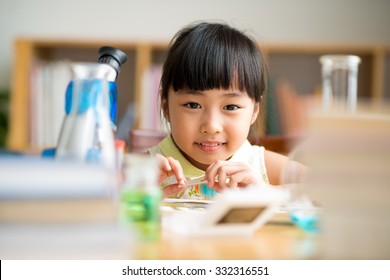 Little Asian Girl Having Science Class, Focus On Face