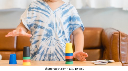 Little asian girl learning materials in a montessori methodology school being manipulated by children.Geometric material in Montessori classroom for the learning of children in mathematics area. - Shutterstock ID 1197104881