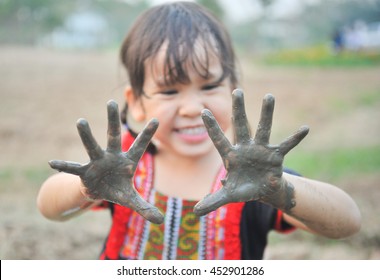 Little Asian Girl Play In A Farm With Mud Dirty Hand