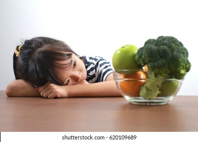 Little Asian Girl Refuse To Eat Healthy Vegetables And Fruits.