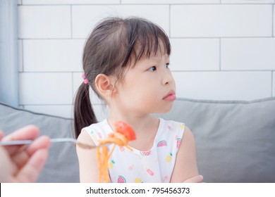 Little Asian Girl Refuse To Eat Tomato In Spagethi From Her Mother,Picky Eater Child Concept.