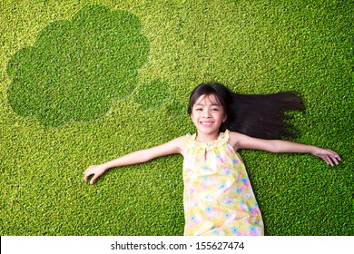 Little asian girl resting on green grass - Powered by Shutterstock