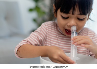 Little Asian Girl Saline Nasal Wash Nose At Home.