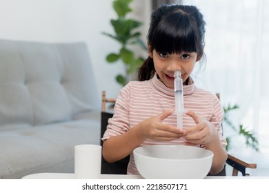 Little Asian Girl Saline Nasal Wash Nose At Home.