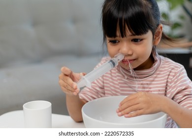 Little Asian Girl Saline Nasal Wash Nose At Home.