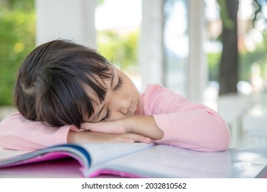 Little Asian Girl Sleeping On The Desk At The Classroom