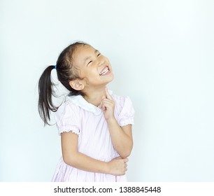 Little Asian Girl Standing And  Looking Up On White Background