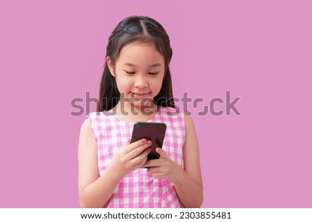 A little asian girl using smart phone, Addicted to technology small kid using smart phone, web surfing internet.