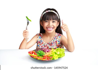 Little asian girl with vegetables food, Isolated over white