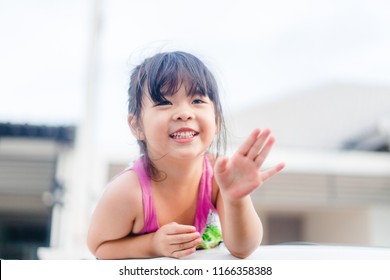 Little Asian Girl Waving Hand For Good Bye In The Moon Roof Car.Concept: Bye Summer And Go To School.Outdoor Portrait: Beautiful Kid Smiling And Waving Say Good Bye.