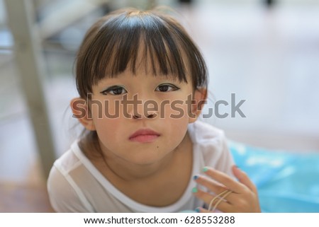 Similar – Funny child looking at the camera and painting