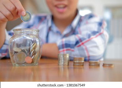 Little Asian Kid Boy Child Children With Coins Stack Jar. Money Savings Cash Deposit For Future