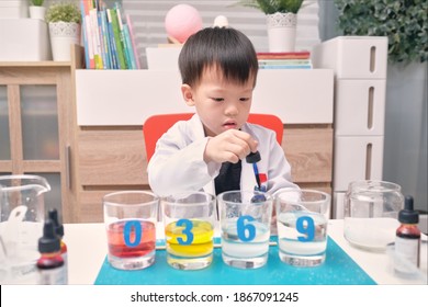 Little Asian Kindergarten Kid Studying Science, Making Sugar Water Density Experiment With Sugar, Water And Food Coloring, Kid-friendly Fun And Easy Science Experiments At Home Concept