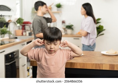 Little Asian Sad Boy, Unhappy While Parents Fighting, Kid Son Not Listen To Shouting Noise While Mom And Dad Arguing, Quarrel Behind. Family Suffering, Stressed. Violence And Divorce Couple Concept.