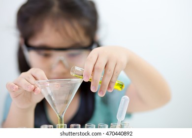 Little Asian Student Girl Making Science Experiment In The Laboratory Class