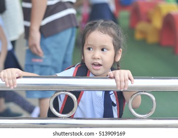 little asian student girl waiting parent after school - Powered by Shutterstock