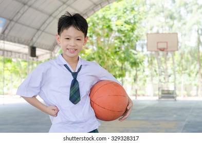 Little Asian Student Holding Basketball At School