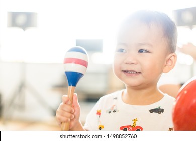 Little Asian Toddler Boy Play Colorful Maracas And Sing A Song In Class Room.Pre Kindergarten Boy Play Music.Child Development EQ And EF.Child With Music Instruments.Musical Education.