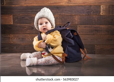 Little baby with backpack is ready for traveling