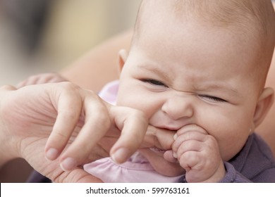 Little Baby Biting Her Mother Finger