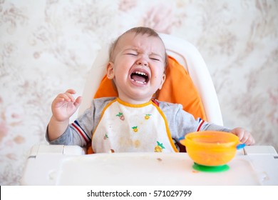 Little Baby Boy Crying And Screaming During Eating, Sitting In Highchair