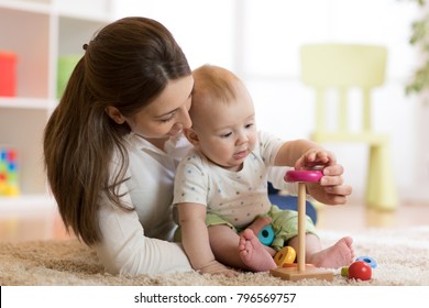 Little Baby Boy And His Mommy Play With Toys At Home