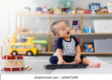 Little baby boy play keyboard and drum at home.Asian boy playing and singing happy moment in music time.