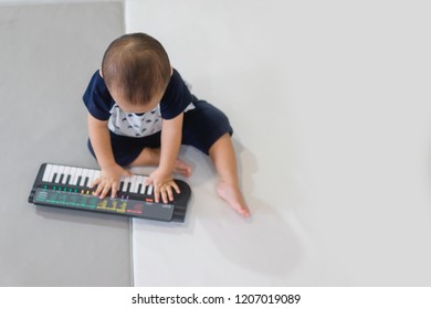 Little Baby Boy Play Keyboard And Drum At Home.Asian Boy Playing And Singing Happy Moment In Music Time.