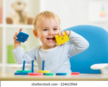 Little Baby Boy Playing With Building Blocks