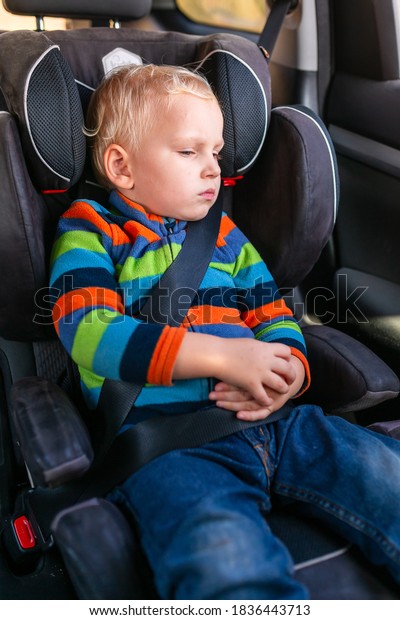 Little baby boy sitting on a car seat\
buckled up in the car. Children\'s Car Seat\
Safety