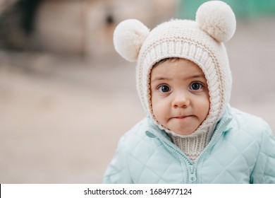 Little Baby Boy In Winter Wear With Fluffy Ears On Knitted Hat. Cute Child Looking To Camera. Family, Son, Love Concept.